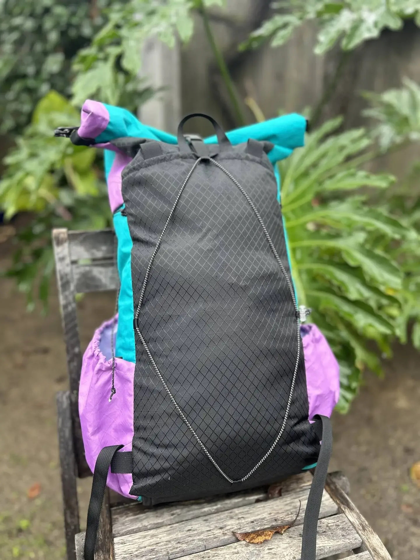 Green and purple pack back view with a black back panel